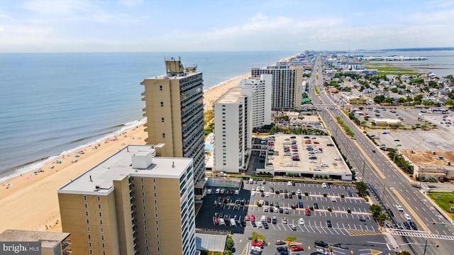 drone / aerial view featuring a view of the beach and a water view