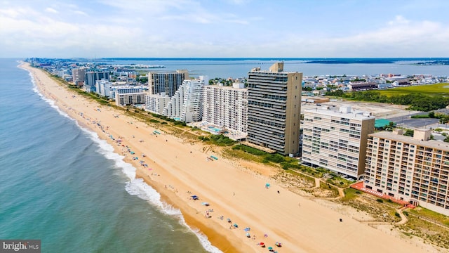 bird's eye view with a water view and a beach view