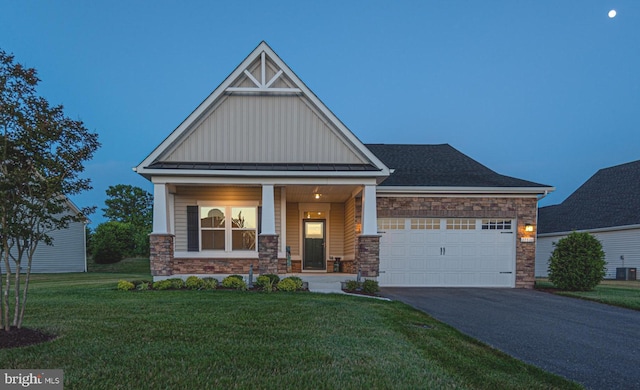 craftsman-style house with a garage, a yard, and covered porch