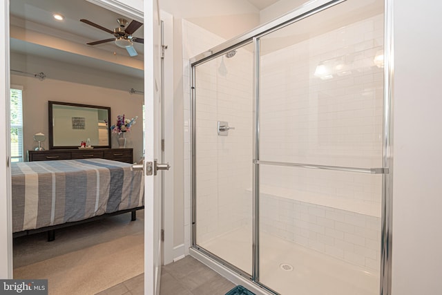 bathroom with a shower with door and ceiling fan