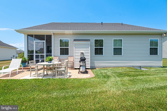 rear view of house with a lawn and a patio