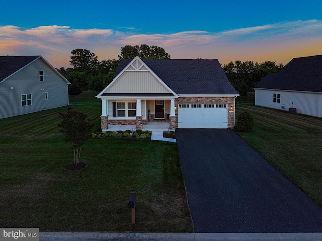 craftsman inspired home with a porch, a garage, and a yard