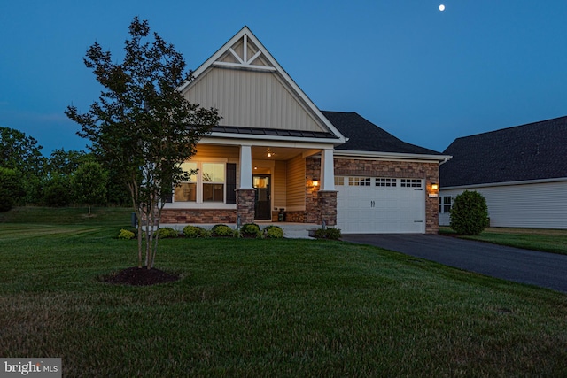 craftsman inspired home with a porch, a garage, and a yard