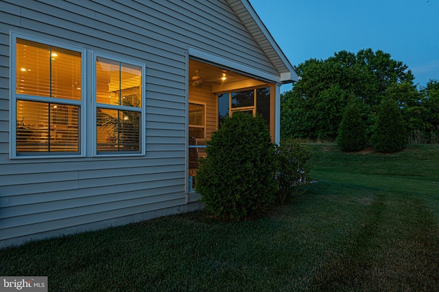 view of side of property with a lawn