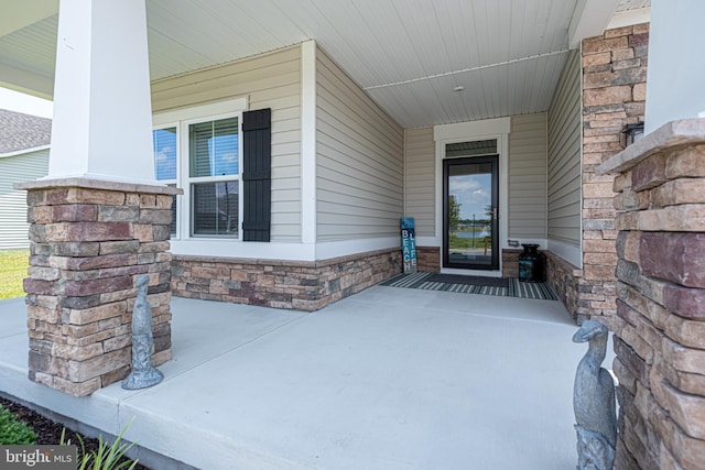 view of exterior entry with covered porch