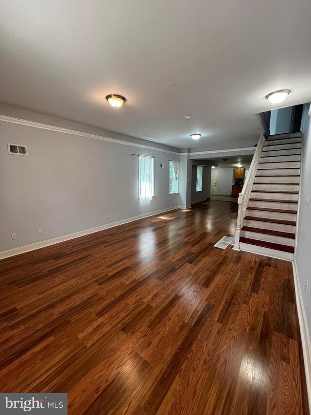 unfurnished living room featuring dark wood-type flooring