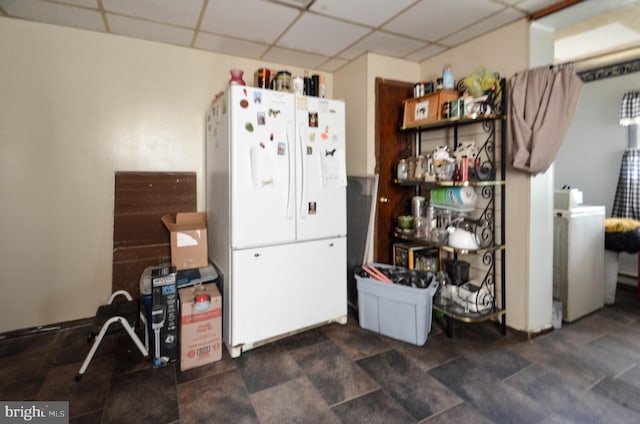 kitchen with white fridge and washer / clothes dryer