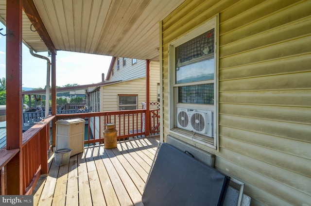 wooden deck featuring ac unit