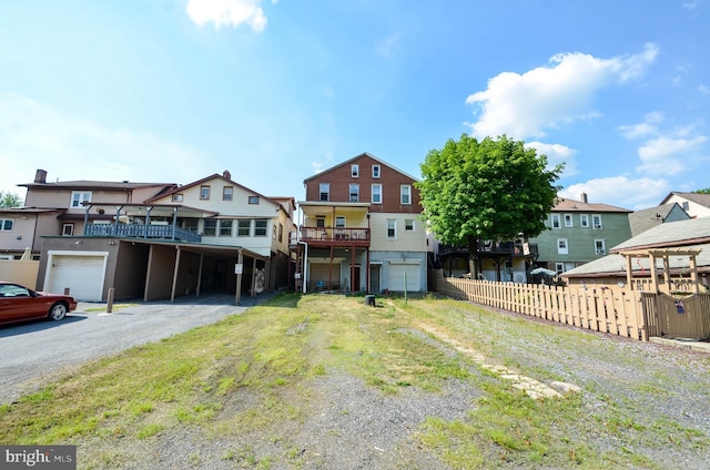 view of front facade with a front yard and a wooden deck