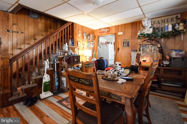 dining room featuring a paneled ceiling and hardwood / wood-style floors