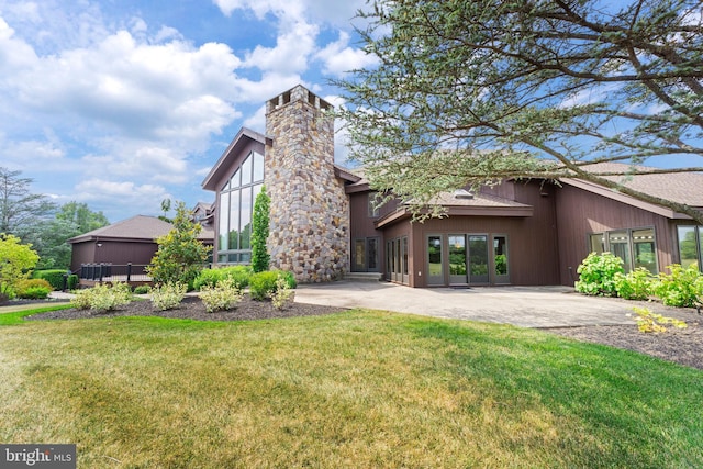 view of front of house with a patio area and a front yard