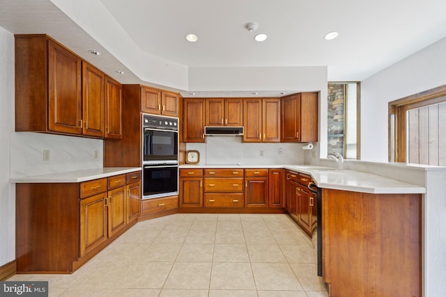 kitchen with sink, light tile patterned floors, and black double oven