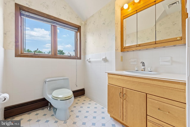 bathroom featuring vanity, a baseboard radiator, lofted ceiling, and toilet