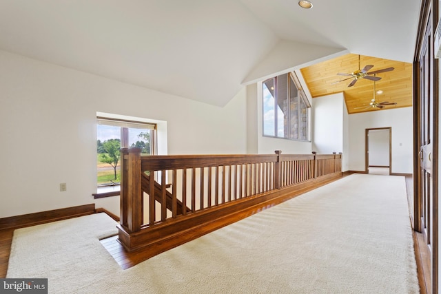 hallway featuring carpet and lofted ceiling