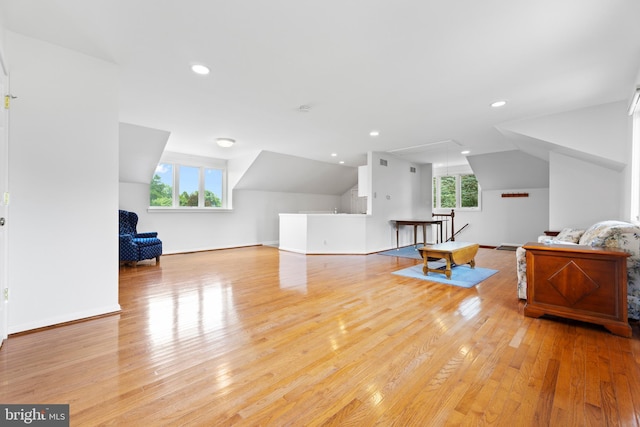 additional living space with lofted ceiling and light wood-type flooring