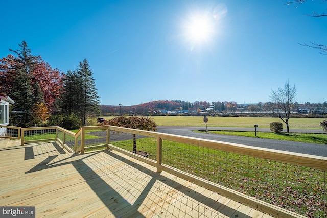 wooden deck featuring a yard