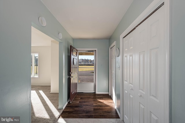 doorway with dark carpet