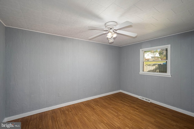 empty room featuring hardwood / wood-style flooring and ceiling fan