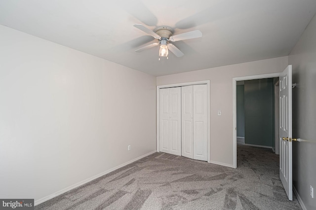 unfurnished bedroom with carpet flooring, ceiling fan, and a closet