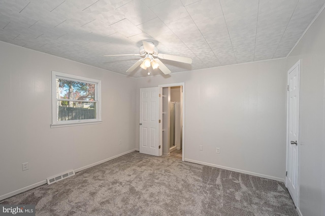 carpeted empty room featuring ceiling fan