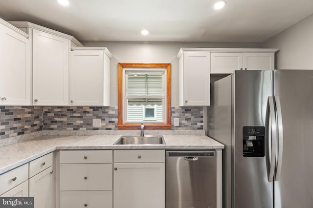 kitchen with sink, white cabinetry, and stainless steel appliances