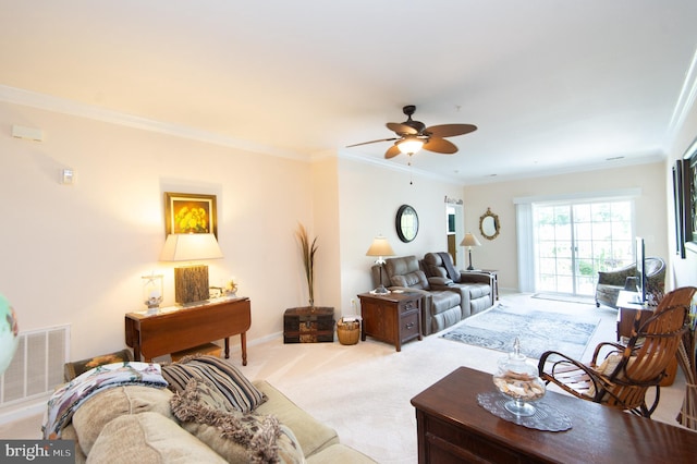 carpeted living room with ceiling fan and ornamental molding