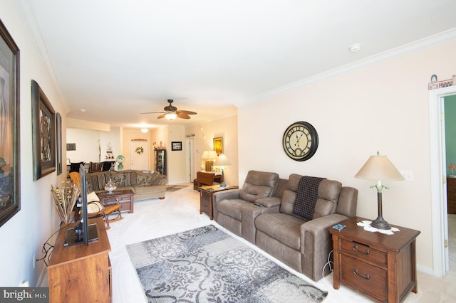 living room with ceiling fan and ornamental molding