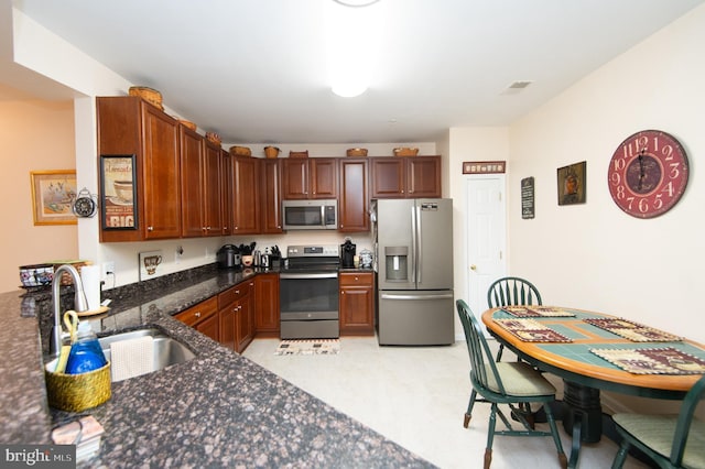 kitchen featuring kitchen peninsula, sink, and appliances with stainless steel finishes