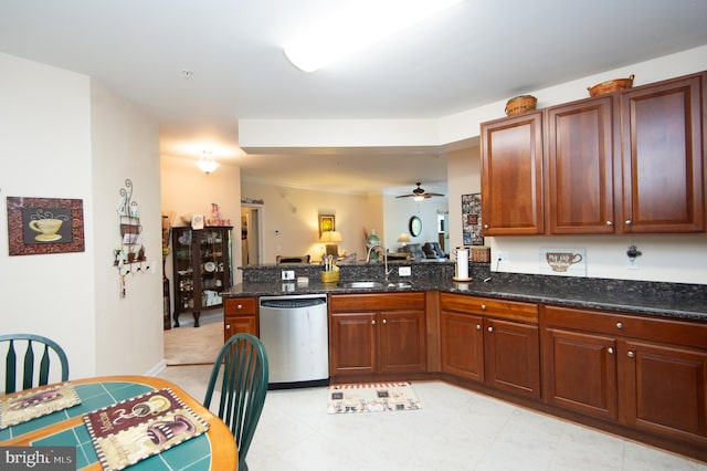 kitchen with kitchen peninsula, stainless steel dishwasher, ceiling fan, sink, and dark stone countertops