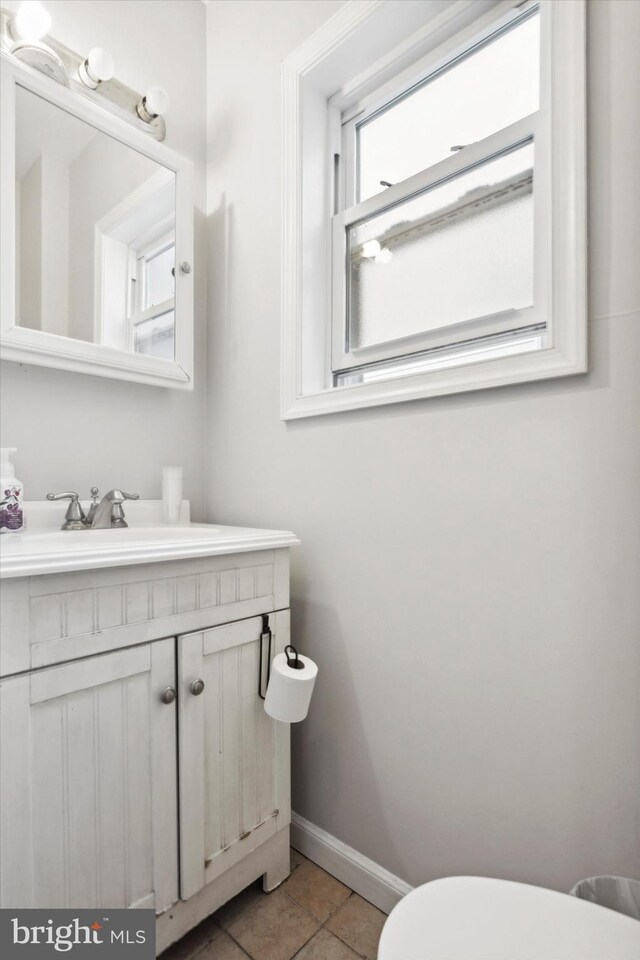 bathroom with vanity, toilet, and tile patterned flooring