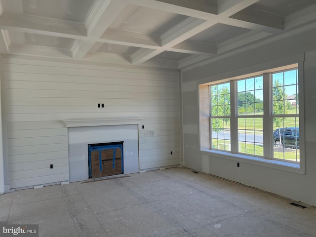 unfurnished living room featuring beamed ceiling, crown molding, a fireplace, and coffered ceiling