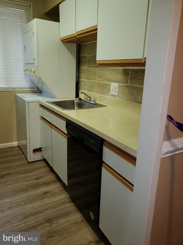 kitchen with sink, black dishwasher, backsplash, light hardwood / wood-style floors, and white cabinets