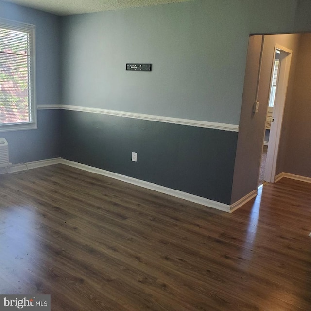 unfurnished room featuring dark hardwood / wood-style floors