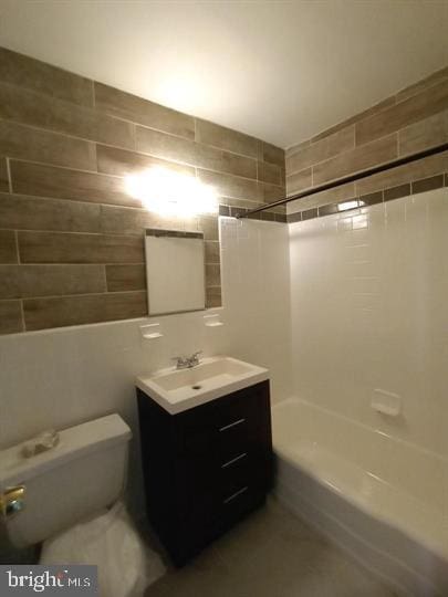 full bathroom featuring bathtub / shower combination, vanity, and toilet