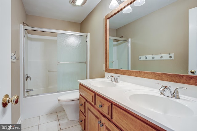 full bathroom with tile patterned floors, vanity, toilet, and enclosed tub / shower combo