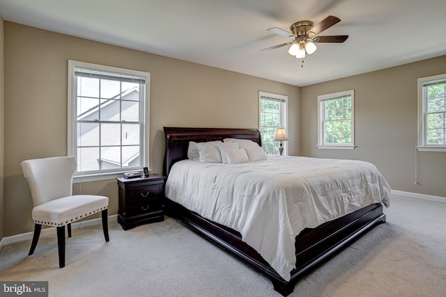 bedroom featuring ceiling fan and light carpet