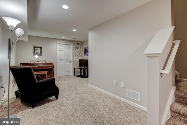 living area featuring light colored carpet