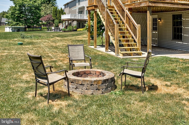 view of yard featuring a fire pit and a wooden deck