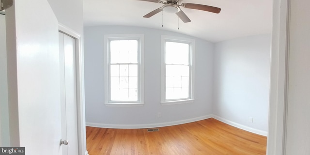 spare room featuring hardwood / wood-style flooring, vaulted ceiling, and ceiling fan