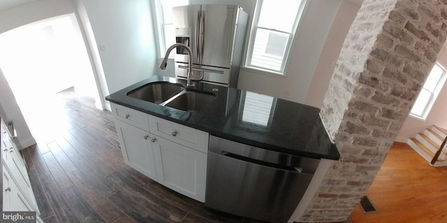 kitchen featuring dark hardwood / wood-style flooring, stainless steel appliances, white cabinetry, and sink