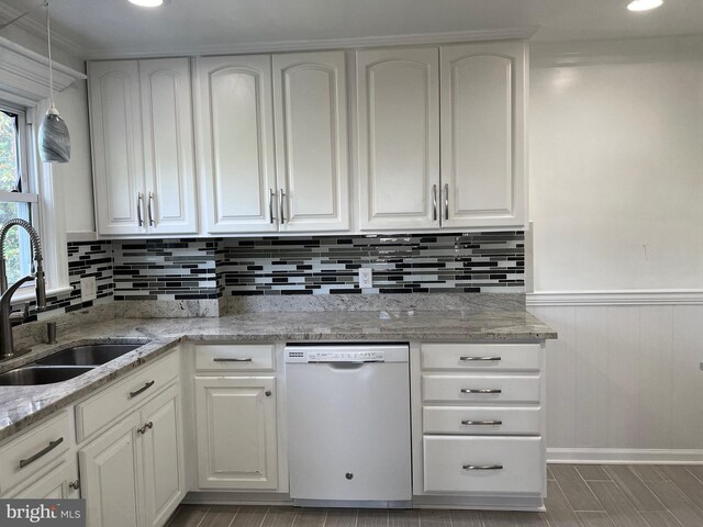 kitchen with dishwasher, white cabinetry, and light stone counters