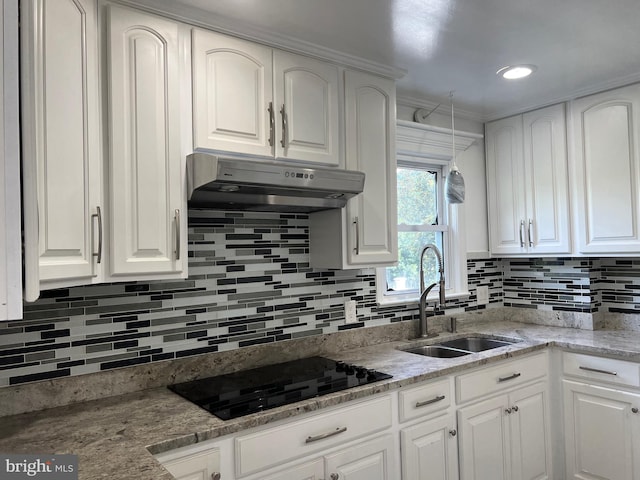 kitchen with white cabinets, black electric stovetop, and sink