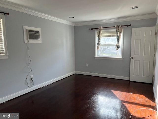 empty room with dark hardwood / wood-style flooring, ornamental molding, and a wall unit AC