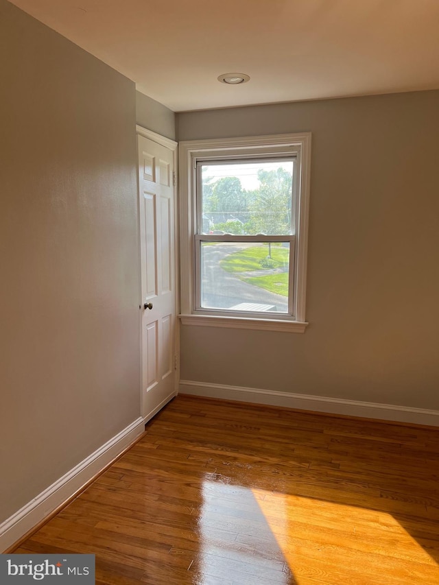 unfurnished room featuring hardwood / wood-style flooring