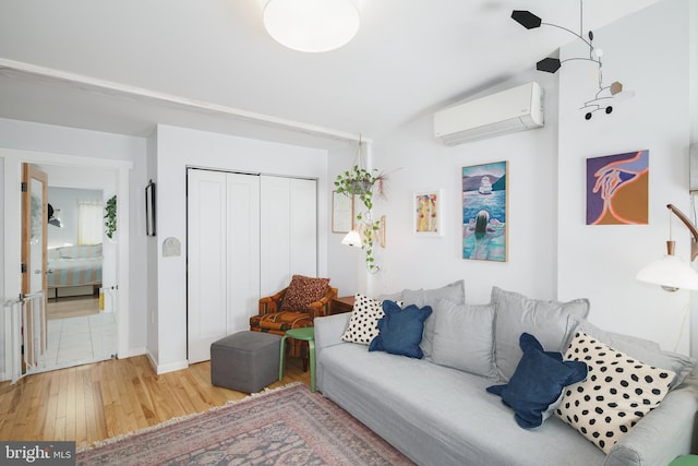 living room featuring hardwood / wood-style flooring and an AC wall unit