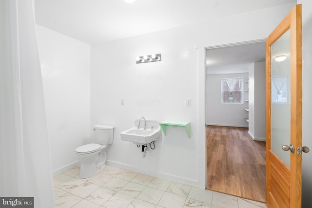 bathroom featuring toilet and sink