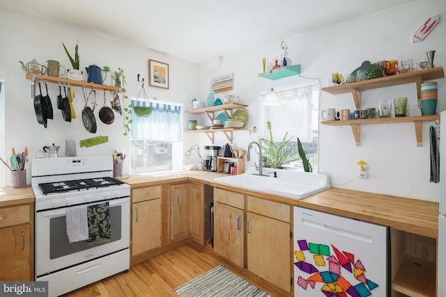 kitchen with sink, light hardwood / wood-style floors, and white appliances