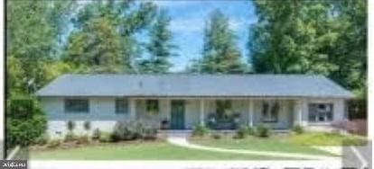 single story home with covered porch and a front lawn