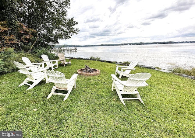 view of yard with a water view and a fire pit