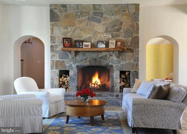 sitting room with a stone fireplace